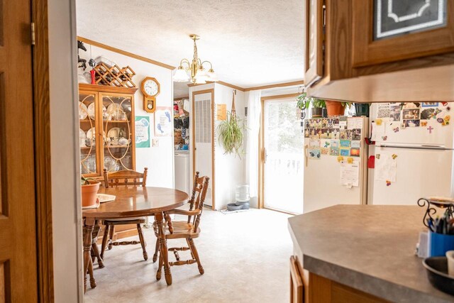 6050 Cth Y, Hazelhurst, WI 53531 - dining area with ornamental molding, a notable chandelier, and a textured ceiling
