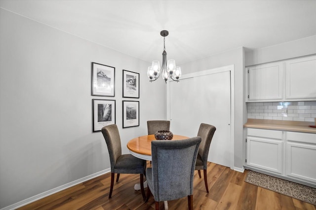 dining area featuring hardwood / wood-style flooring and a chandelier