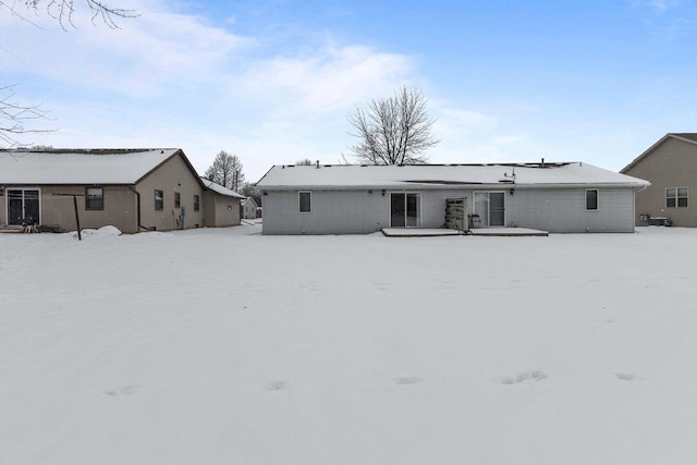 view of snow covered rear of property