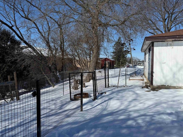 yard layered in snow featuring fence