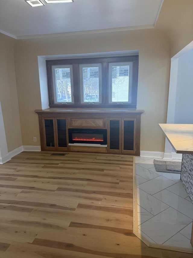 interior space featuring hardwood / wood-style flooring and ornamental molding