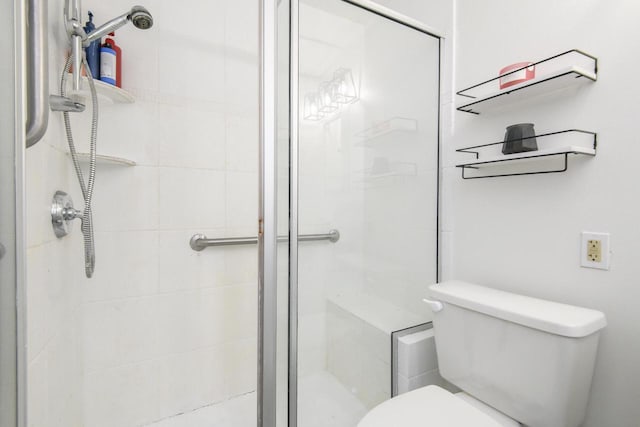 full bath with a stall shower and toilet