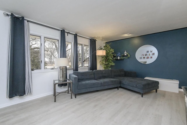 living room featuring light wood-type flooring and baseboards