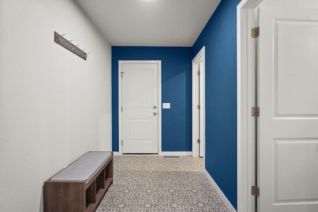 hallway featuring baseboards