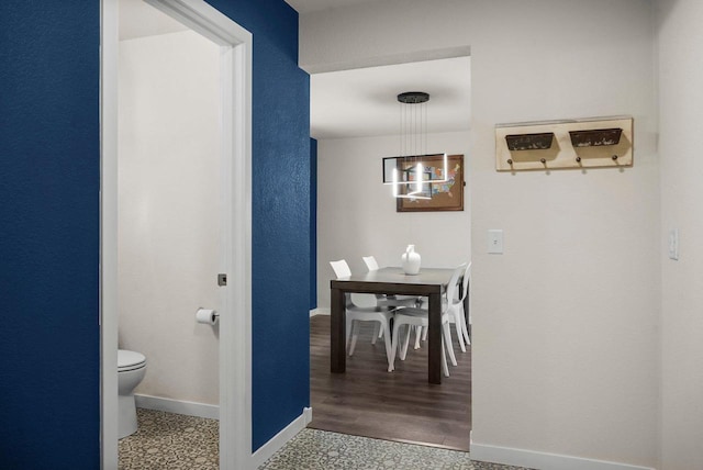 interior space with toilet and baseboards