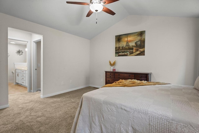 bedroom featuring baseboards, a ceiling fan, lofted ceiling, ensuite bath, and carpet