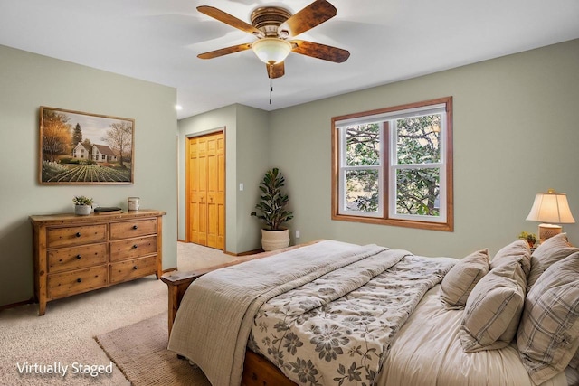 bedroom featuring a ceiling fan and light colored carpet