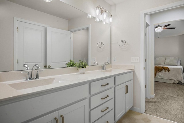 ensuite bathroom with ceiling fan, a sink, ensuite bath, and double vanity