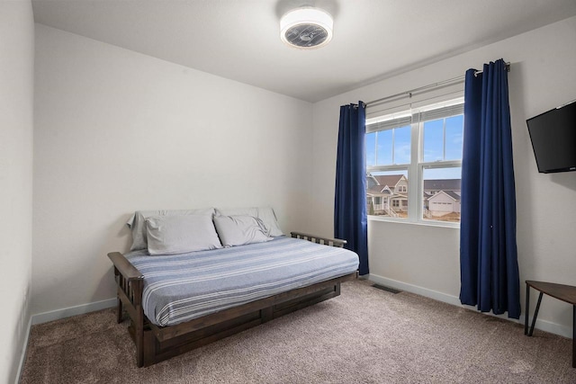 carpeted bedroom featuring visible vents and baseboards