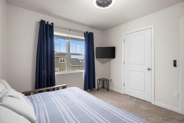 carpeted bedroom featuring visible vents and baseboards