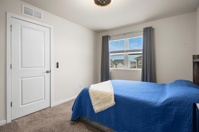 carpeted bedroom with visible vents and baseboards