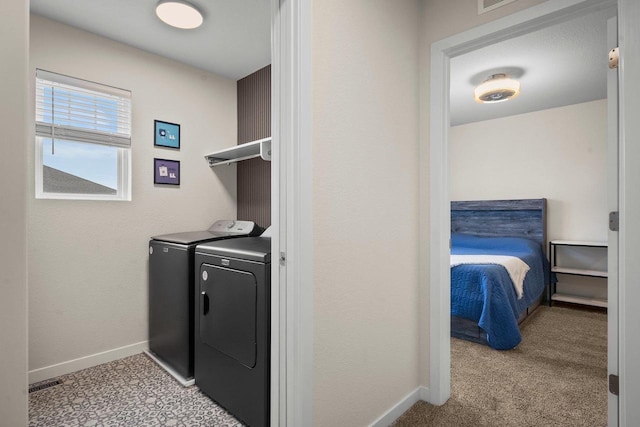 laundry room with light carpet, laundry area, baseboards, and washer and clothes dryer