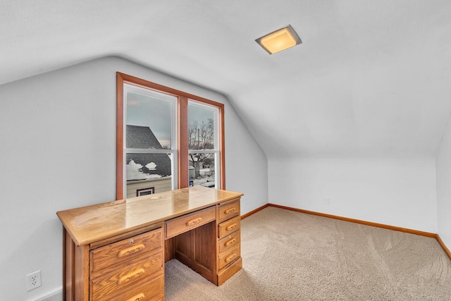 office area featuring lofted ceiling and light colored carpet