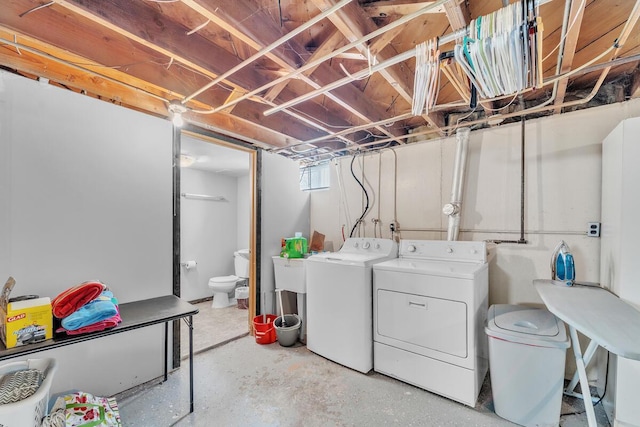 clothes washing area featuring washer and clothes dryer