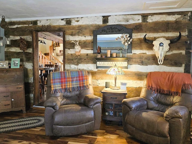 living area featuring hardwood / wood-style floors and ornamental molding