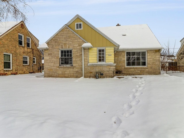 view of snow covered back of property