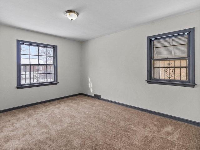 empty room featuring light carpet