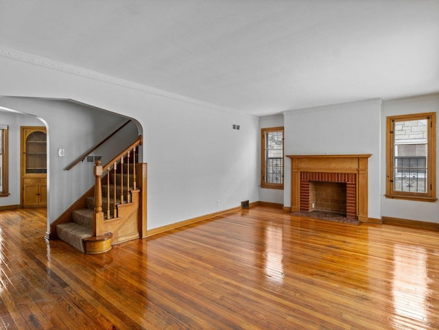 unfurnished living room with wood-type flooring and a fireplace