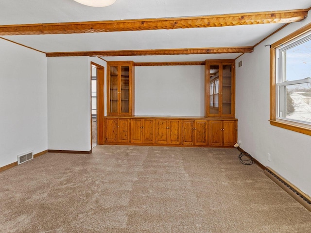 carpeted spare room featuring beam ceiling and baseboard heating