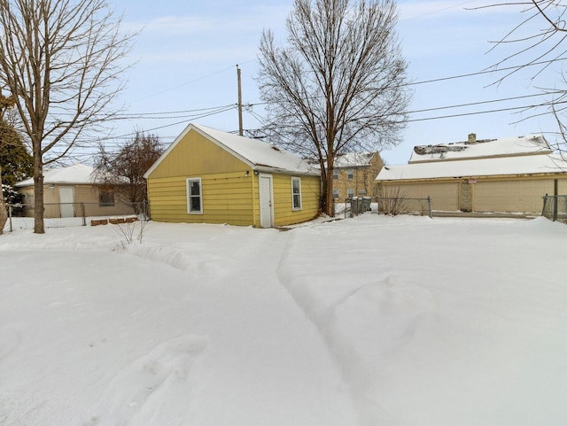 yard covered in snow with a garage