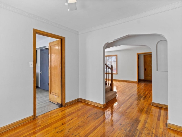 empty room featuring ornamental molding and wood-type flooring