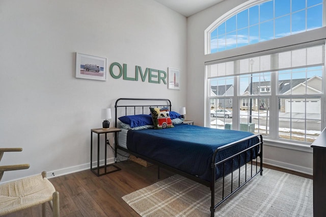 bedroom with baseboards and wood finished floors