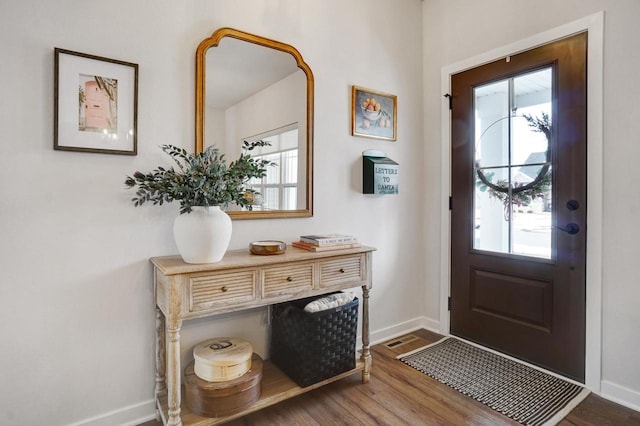 entryway with baseboards, wood finished floors, and a healthy amount of sunlight