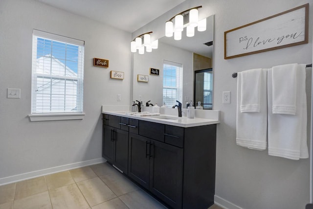 bathroom featuring a healthy amount of sunlight, a stall shower, baseboards, and tile patterned floors