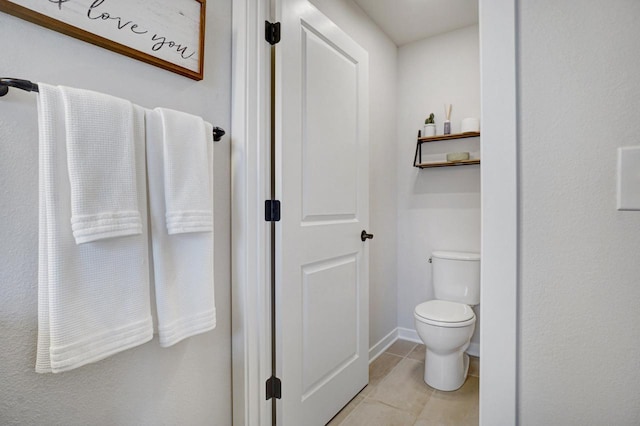 bathroom with toilet and tile patterned floors