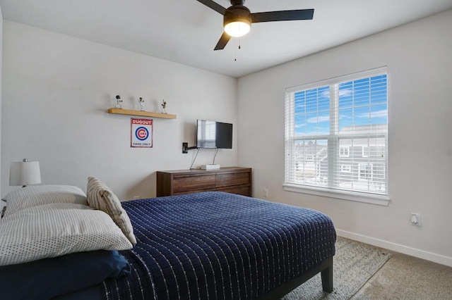 bedroom featuring light carpet, ceiling fan, and baseboards