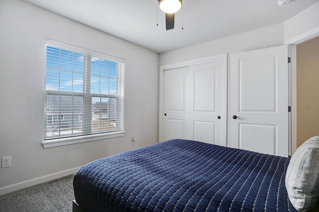 bedroom featuring ceiling fan, baseboards, and a closet