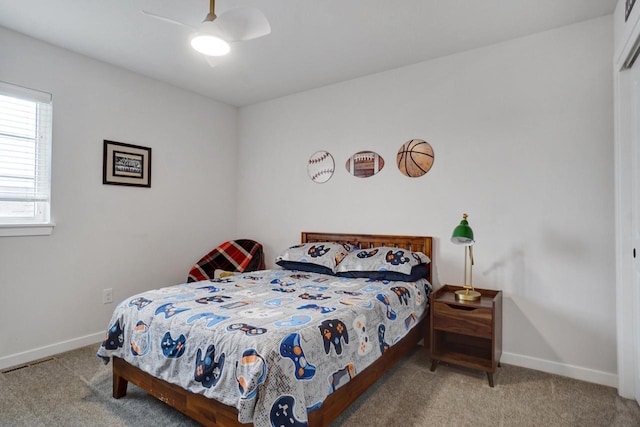 carpeted bedroom with a ceiling fan, visible vents, and baseboards