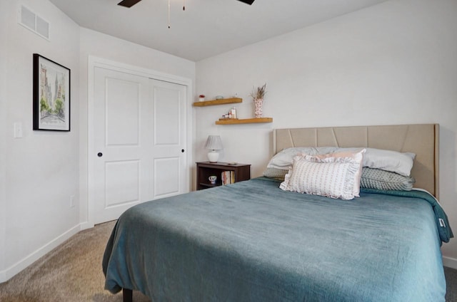 bedroom featuring a closet, visible vents, carpet flooring, ceiling fan, and baseboards