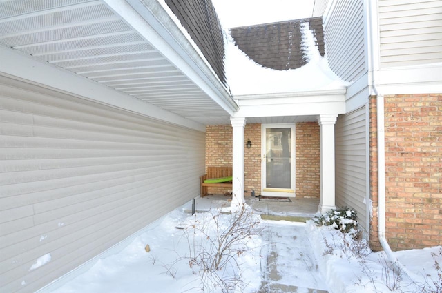 view of snow covered property entrance