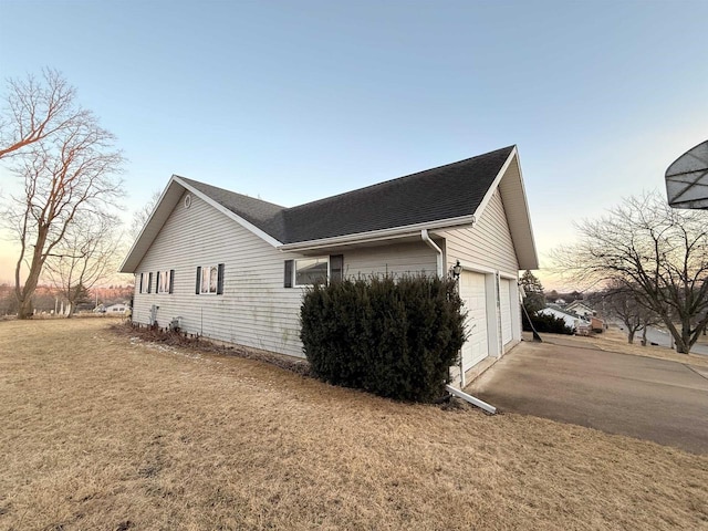 414 S Wisconsin St, Mineral Point, WI 53565 - view of home's exterior with driveway, a lawn, an attached garage, and roof with shingles