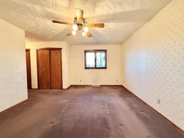 414 S Wisconsin St, Mineral Point, WI 53565 - empty room featuring wallpapered walls, visible vents, baseboards, ceiling fan, and carpet