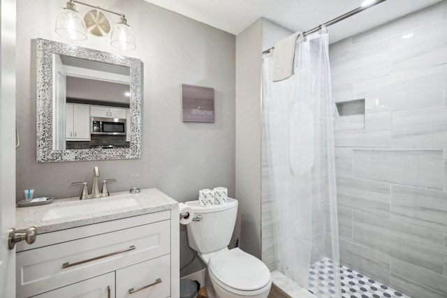 bathroom with vanity, a shower with curtain, and toilet