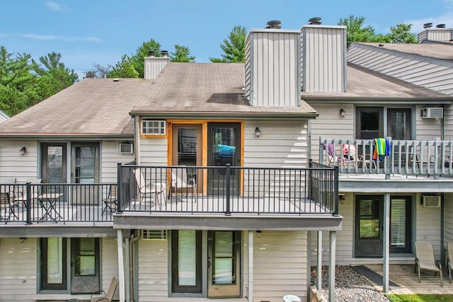 rear view of property featuring an AC wall unit