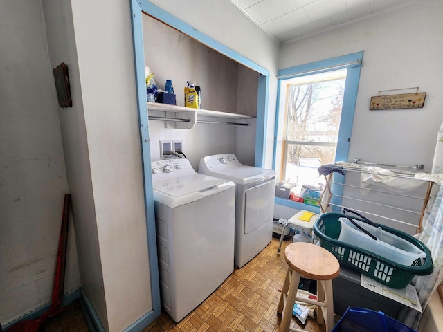 laundry area with separate washer and dryer and light parquet floors