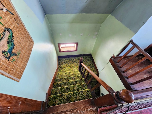 staircase featuring lofted ceiling