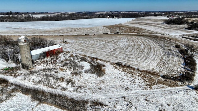 snowy aerial view featuring a rural view