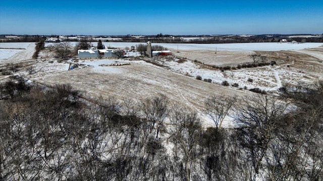 snowy aerial view featuring a rural view