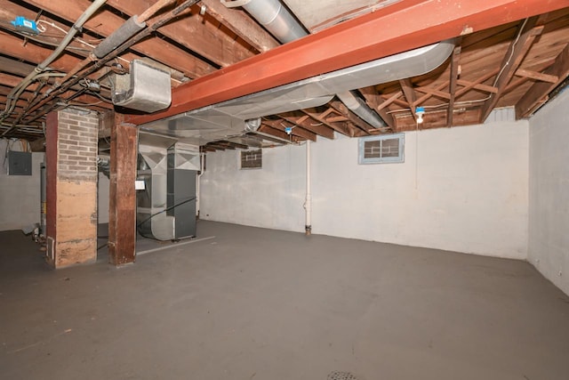 basement with heating unit and electric panel