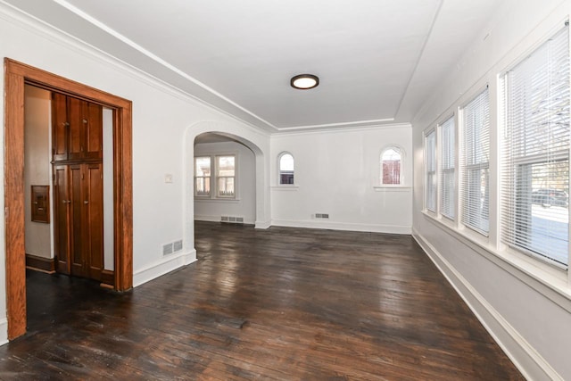 unfurnished room with crown molding and dark hardwood / wood-style floors