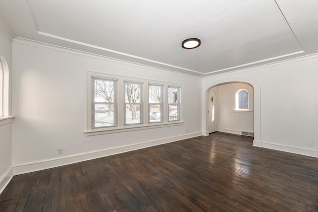 empty room featuring dark hardwood / wood-style floors and ornamental molding