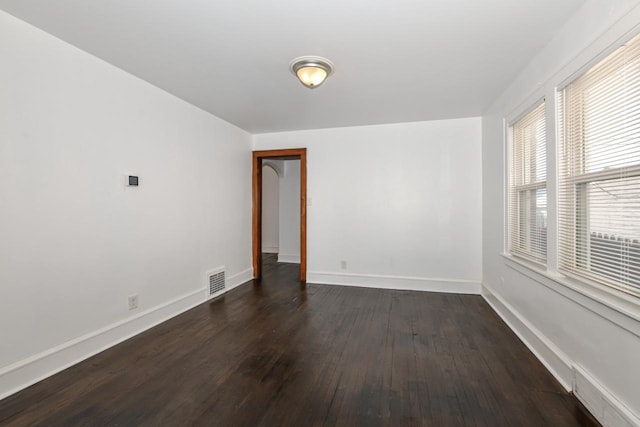 spare room featuring dark hardwood / wood-style floors