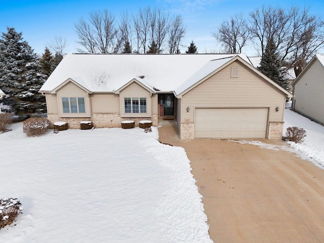 view of front facade with brick siding, concrete driveway, and an attached garage