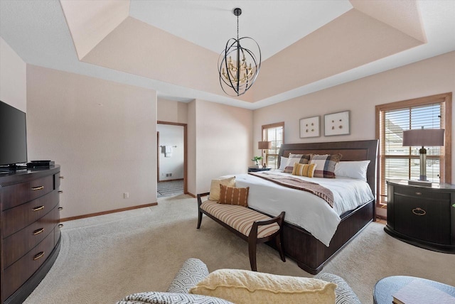 bedroom featuring a tray ceiling, light colored carpet, a notable chandelier, and baseboards