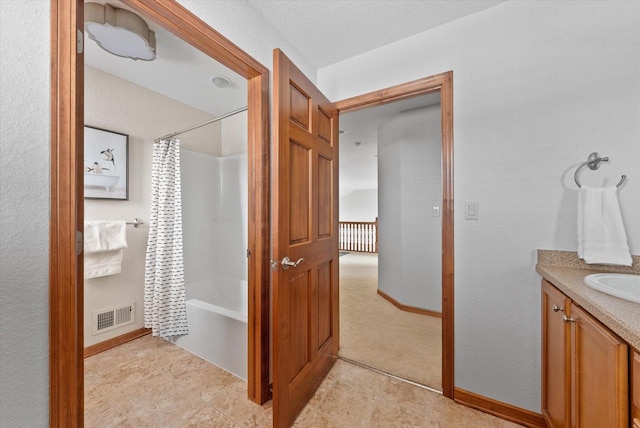 full bathroom featuring shower / bath combo, vanity, visible vents, and baseboards