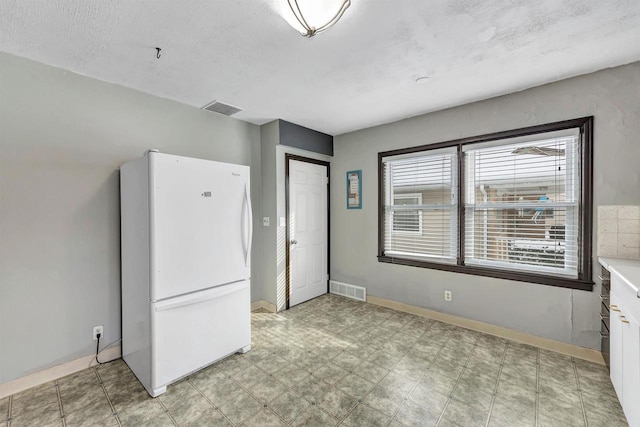 empty room with a textured ceiling